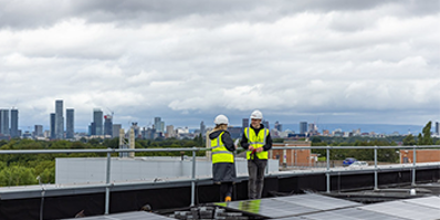 Engineers in high vis talking outside